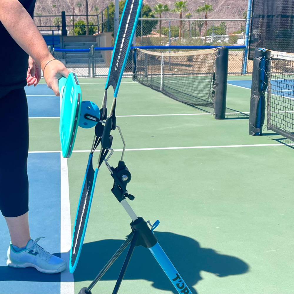 Player hitting a forehand on the TopspinPro, side view